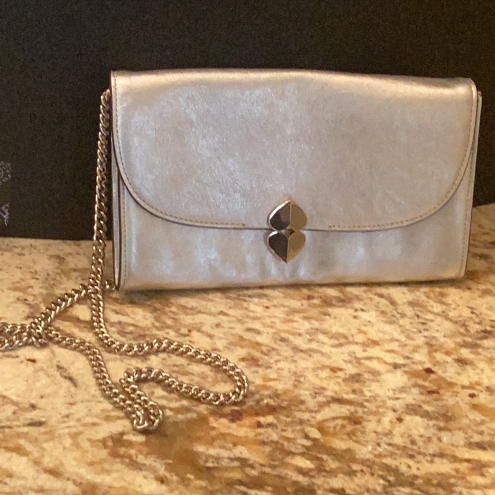 Kate Spade silver crossbody with silver chain.